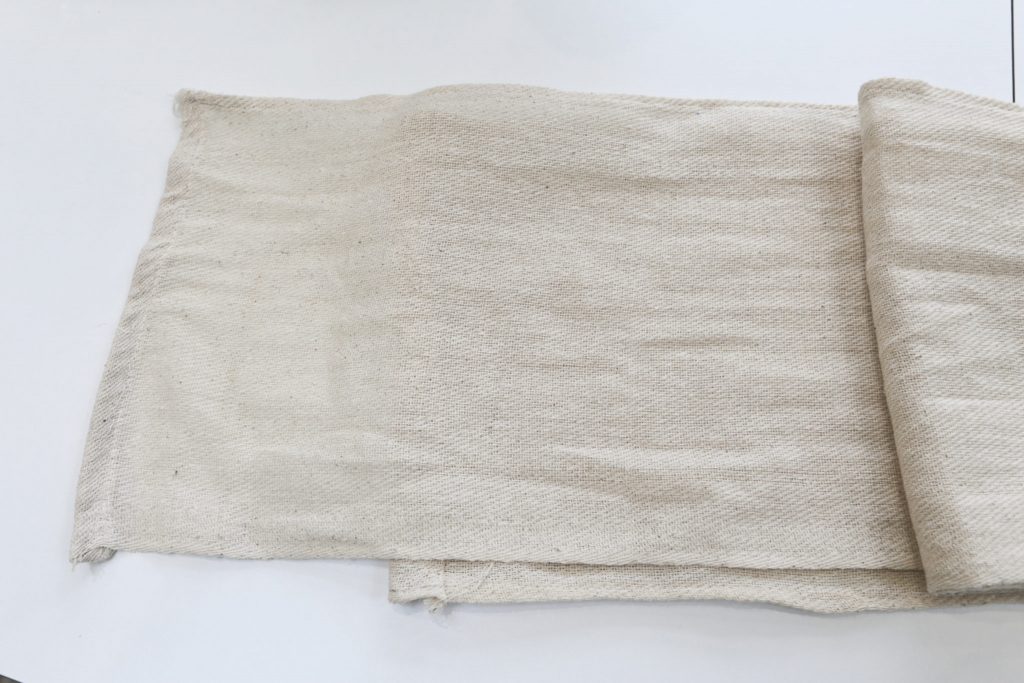 The cotton twill dust sheet was divided into three eaual width panels of 1 ft by 6 foot and stitched together in a long piece