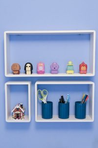 B & Q White Cube Shelves fitted to blue bderoom wall and filled with Emily's ornaments and pens, pencils and ornaments