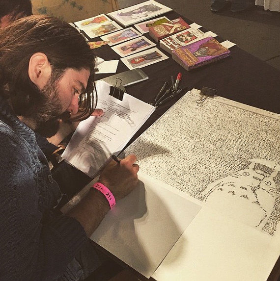 Mike Matola sitting at his desk and working on his Totoro line-by-line drawing