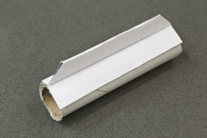 The cardboard tube from an aluminium foil roll with one of the cardboard fins glues to it. This needs to be repeated until there are 4 fins around the tube at 90, 180, 270, 360 degrees.