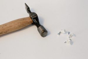 Close-up of pin hammer and cable tidy tacks.