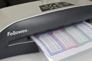 A printable in a laminated pouch being fed into the Fellowes Callisto A4 Laminator