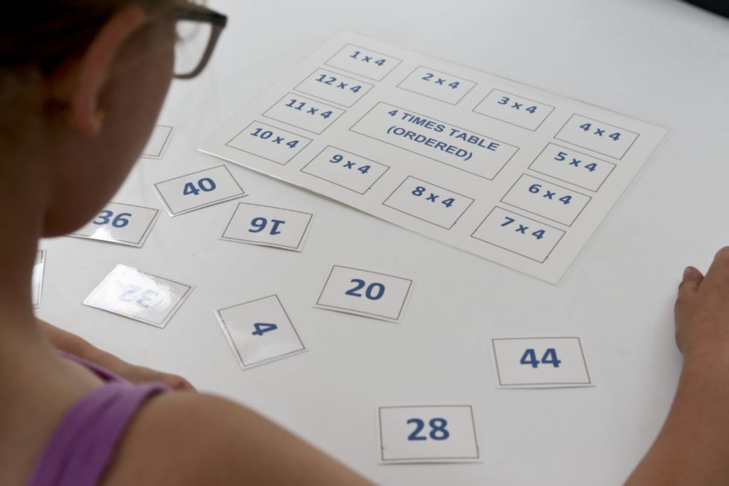 Girl playing Laminated multiplication game