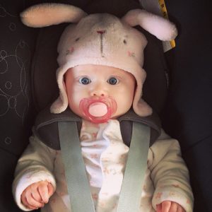 My Niece in her rabbit ear hat in a carseat