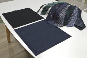 The ties, cushion pad, 15inch square lining and denim fabrics laid on a table prior to making the cushion