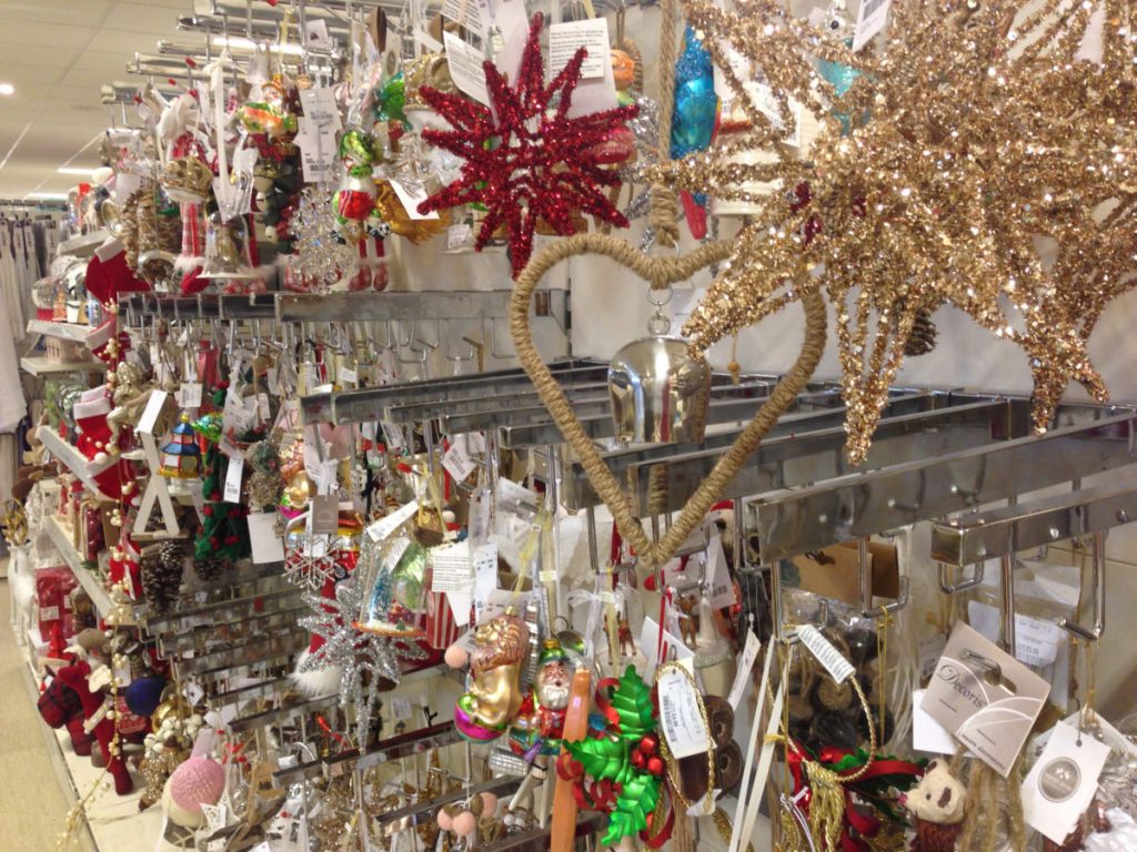 Lots of Christmas decorations hanging on the shelves at Homesense