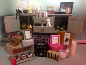 Christmas gifts on top of and in the drawers of a sideboard