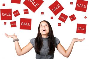 Be prepared to grab a bargain when you shop in the Black Friday / Cyber Monday sales. Lady with sales signs above her head