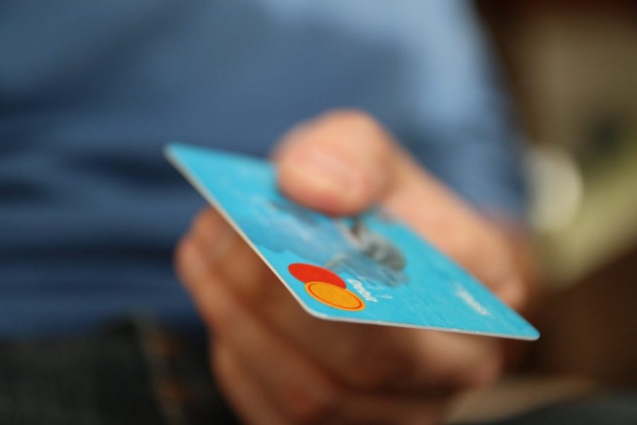 ClearScore have published a guide on personal loans. Close-up of hand holding a credit card