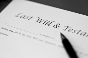 Pen resting on Last Will & Testament document: Article on 10 reasons why you need to write a will and Free will
