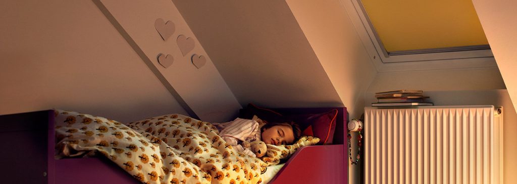 child in bed with velux blackout blinds