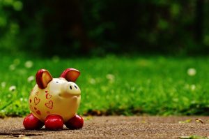 Yellow Piggy Bank with grass in background