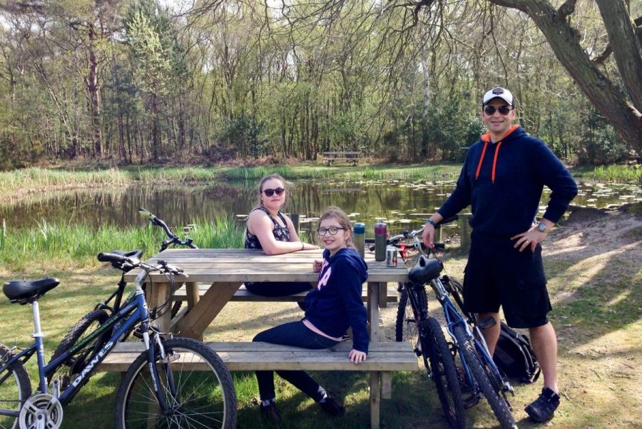 Sitting at picnic bench beside pond on Kelling Heath Holiday Park Cycle route