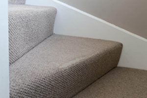 Worn carpet on high traffic areas like stairs